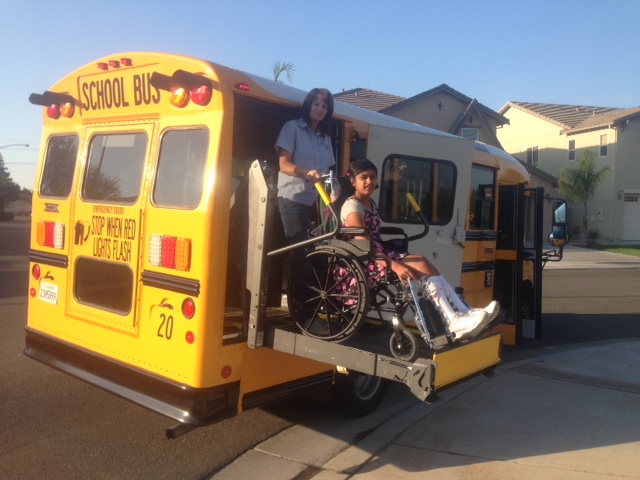 student on a special needs bus with her driver